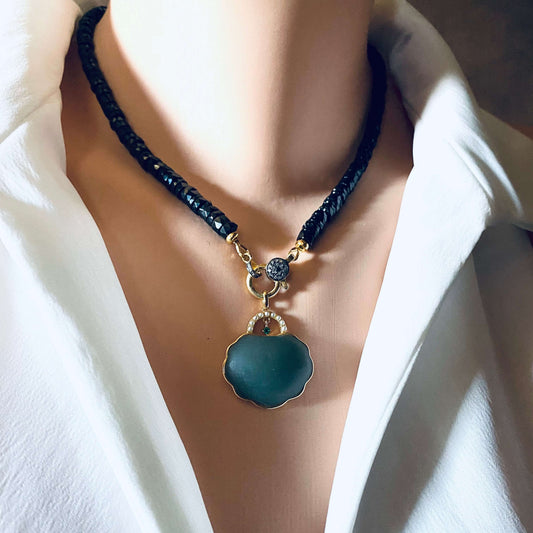Hotan jade purse pendant with pearl detail in gold vermeil on a black necklace, showcased on a mannequin.