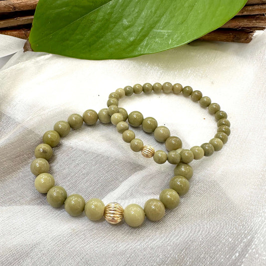 Green Olivine Jasper Bracelet pair displayed on cloth – two-bracelet close-up