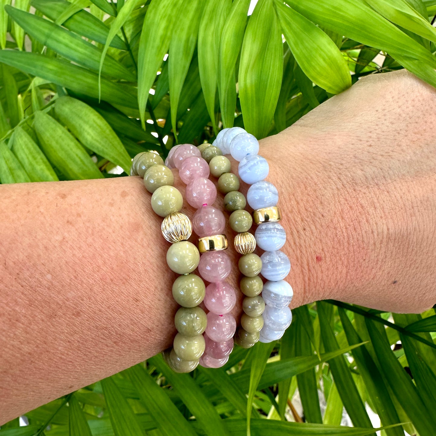 Blue Lace Agate Bracelet worn with mixed bracelets on woman’s wrist – layered style