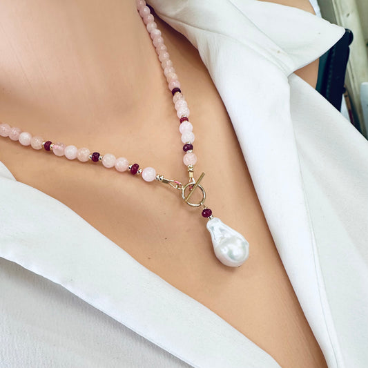 Side close-up of morganite necklace with ruby accents worn on mannequin