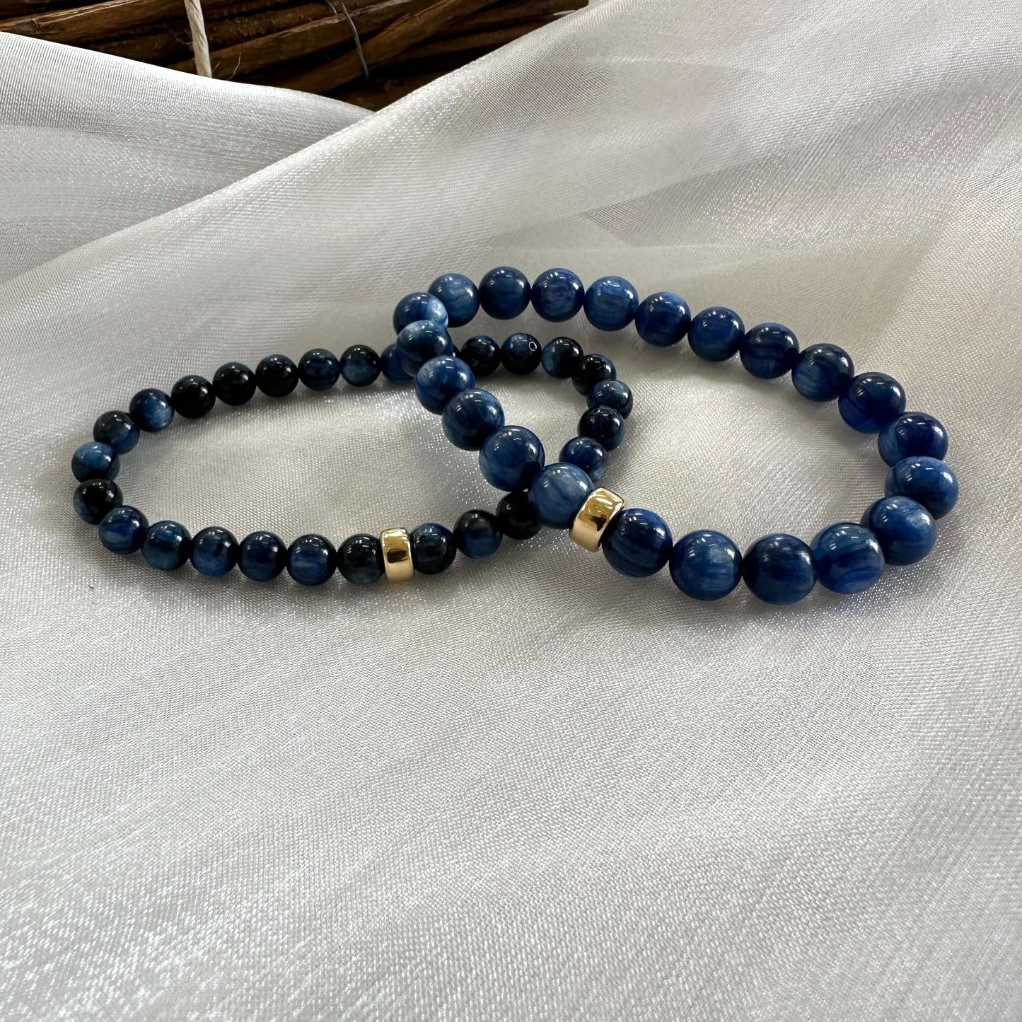 Two blue kyanite bracelets displayed together on white cloth