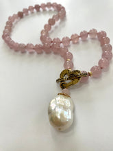 Load image into Gallery viewer, Smooth 8mm hand knotted rose quartz round bead necklace with a baroque pearl pendant, featuring an artisan gold bronze heart toggle clasp and gold-filled details. The necklace is 17.5 inches long and makes a thoughtful January birthstone gift