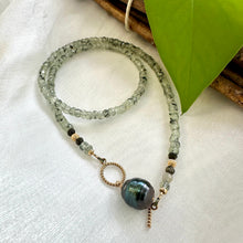 Charger l'image dans la galerie, This necklace features a delicate chain of soft, translucent faceted green Prehnite rondelle beads, beautifully complemented by a striking Tahitian baroque pearl as the centerpiece pending from a cold filled toggle clasp. 18"inches long