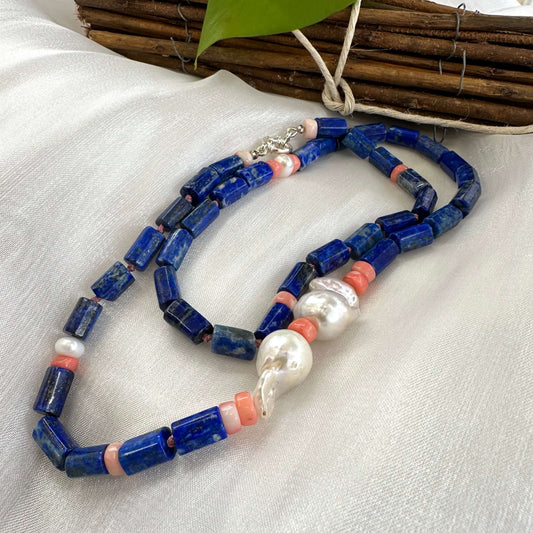 Lapis lazuli necklace with pink coral and baroque pearls - Handmade jewelry showcasing deep blue and vibrant pink accents.