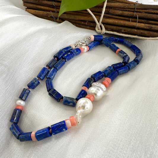 Lapis lazuli necklace with pink coral and baroque pearls - Handmade jewelry showcasing deep blue and vibrant pink accents.