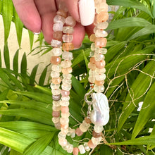 Carica l'immagine nel visualizzatore di Gallery, Hand-knotted necklace with mixed moonstone and a baroque pearl at the center, threaded with orange string, 20 inches long, featuring a sterling silver marine clasp.