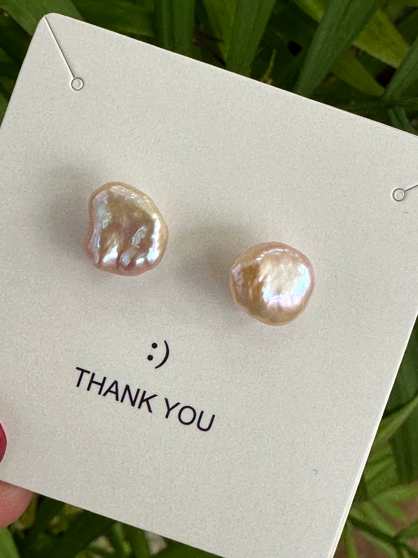 Delicate pink keshi pearl stud earrings in sterling silver on a card with a thank you note.