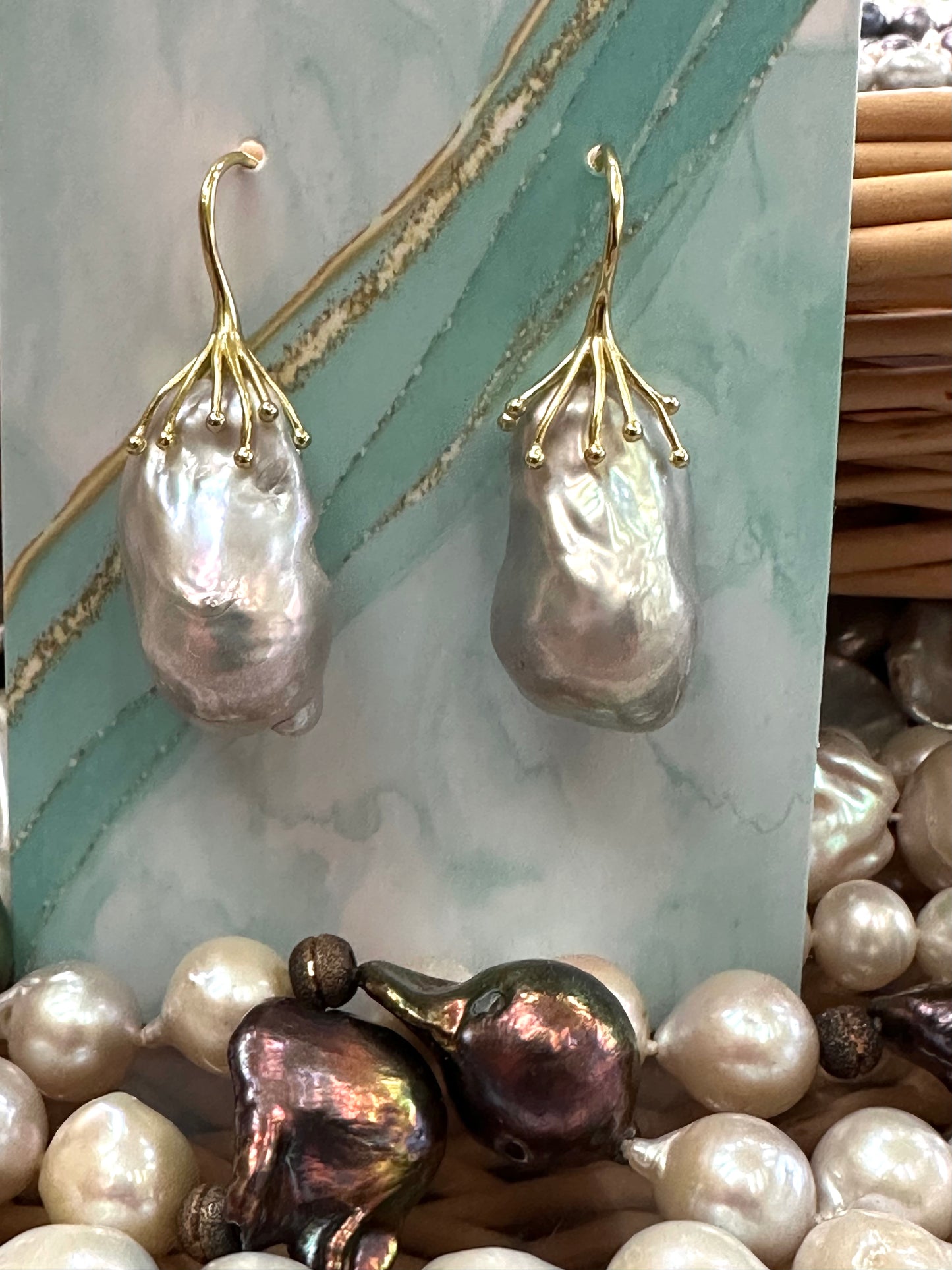 Golden version of silver grey baroque pearl drop earrings displayed on turquoise packaging, showing warm gold vermeil finish.