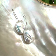 Load image into Gallery viewer, White freshwater pearl drop earrings rhodium-plated silver close-up on white pearl shell, rectangular design handmade in Canada.