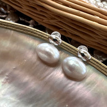 Load image into Gallery viewer, Silver grey nugget pearl stud earrings shown at an angle on pearl shell, elegant freshwater design handmade in Canada.
