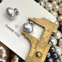 Load image into Gallery viewer, Silver grey nugget pearl stud earrings measured against ruler for size, rhodium-plated silver handmade in Canada.