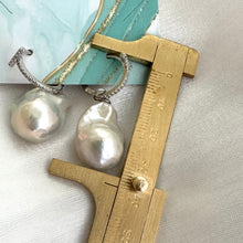 Cargar imagen en el visor de la galería, White Baroque Pearl Earrings – silver design measured for size against ruler