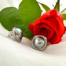 Carica l'immagine nel visualizzatore di Gallery, Mabe Pearl Earrings – close-up beside red rose on white fabric background
