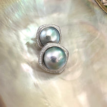Carica l'immagine nel visualizzatore di Gallery, Mabe Pearl Earrings – close-up against white pearl shell backdrop