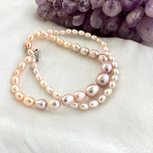 Carica l'immagine nel visualizzatore di Gallery, Close-up of Rice Pearl Necklace showing pastel freshwater pearls beside amethyst stone on white cloth.