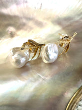 Cargar imagen en el visor de la galería, Close-up of handcrafted Baroque Pearl Earrings with oak leaf gold vermeil design displayed on white pearl shell background.