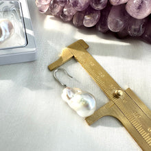 Charger l'image dans la galerie, White baroque pearl bridal earrings measured for full drop length on white cloth, designed and handmade in Canada.