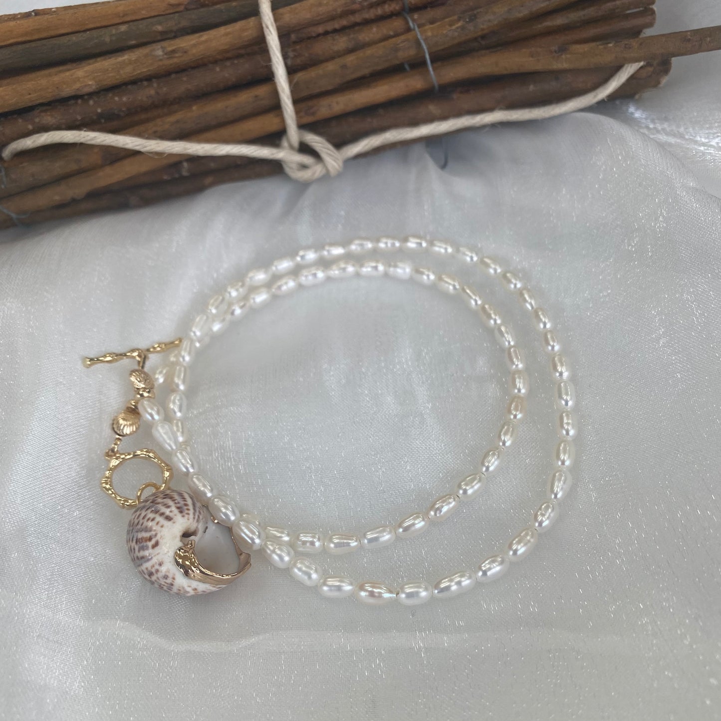 Real seashell pendant pearl necklace displayed flat highlighting seashell charm and pearl details