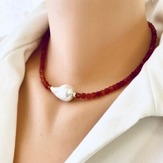 Carnelian pearl necklace featuring burnt orange carnelian cube beads and a white pearl centerpiece, elegant jewelry design.