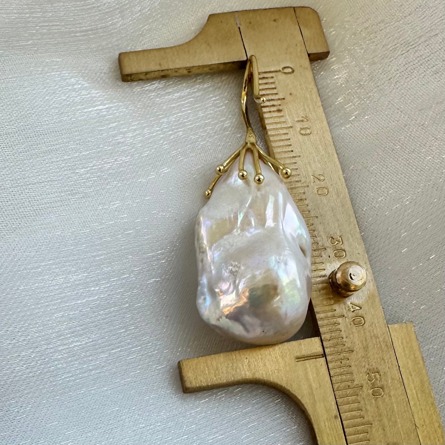 Baroque pearl drop earring size comparison with ruler, white freshwater pearls shown in detail