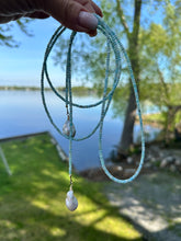 Charger l'image dans la galerie, Blue Larimar Lariat Necklace held against lake and grass background — natural gemstone and pearl necklace handcrafted by Loulia Pearl Jewelry