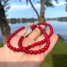 Cargar imagen en el visor de la galería, red coral and one large baroque pearl on the side of the necklace with sterling silver details, measuring 18 inches. This vibrant jewelry piece makes a thoughtful gift for her.
