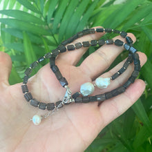 Cargar imagen en el visor de la galería, Navy Blue Iolite Rectangular Beads and 2 Baroque Pearls off centre Necklace. Finished with sterling silver details, this necklace brings together luxury and durability. The adjustable length, ranging from 19 to 20 inches, ensures a perfect fit