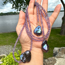 Load image into Gallery viewer, Handcrafted Amethyst and Black Baroque Pearl Lariat Necklace photographed in nature — elegant gemstone and pearl design by Loulia Pearl Jewelry