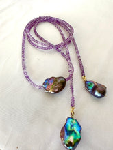 Load image into Gallery viewer, Close-up of Amethyst and Black Baroque Pearl Lariat Necklace on white background — faceted amethyst beads and baroque pearls handcrafted by Loulia Pearl Jewelry