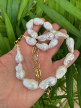 Cargar imagen en el visor de la galería, Handcrafted baroque pearl gold chain necklace photographed outdoors with leafy green background — natural light lifestyle jewelry photo by Loulia Pearl Jewelry
