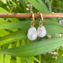 Cargar imagen en el visor de la galería, White Baroque Pearl Earrings – close-up against green leaf background