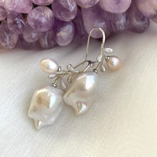 Cargar imagen en el visor de la galería, Handmade baroque pearl earrings in silver resting on white and amethyst background