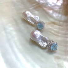 Cargar imagen en el visor de la galería, Blue topaz pearl drop earrings displayed on white pearl shell background