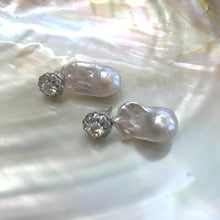 Lade das Bild in den Galerie-Viewer, Moissanite and baroque pearl earrings close-up on white pearl shell, handcrafted in Canada.