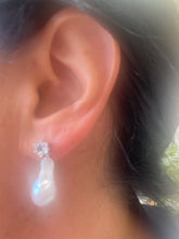 Cargar imagen en el visor de la galería, Side view of woman wearing Baroque pearl drop earrings with blue topaz studs