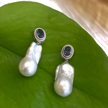 Cargar imagen en el visor de la galería, Iolite baroque pearl drop earrings photographed against green leaf background — elegant natural light jewelry shot by Loulia Pearl Jewelry
