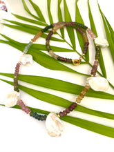 Carica l'immagine nel visualizzatore di Gallery, Multi tourmaline and keshi pearl necklace displayed on white and green leaf backdrop, boho-chic style.