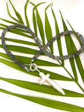 Load image into Gallery viewer, Handcrafted labradorite necklace with pearl cross photographed outdoors with green leaves — artisan jewelry by Loulia Pearl Jewelry