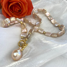 Carica l'immagine nel visualizzatore di Gallery, Close-up of golden baroque pearl toggle necklace on white background — CZ pavé gold cube accents and lustrous pearls by Loulia Pearl Jewelry