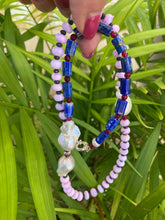 Cargar imagen en el visor de la galería, Lapis lazuli opal agate pearl necklace held against green leafy background — handcrafted gemstone and baroque pearl jewelry by Loulia Pearl Jewelry