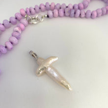 Carica l'immagine nel visualizzatore di Gallery, → Baroque pearl cross pendant close-up beside lavender opal necklace, luminous handcrafted detail.