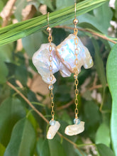 Lade das Bild in den Galerie-Viewer, Close-up of boho pearl earrings gold filled photographed with green leaves — natural light jewelry shot showing blue topaz accent stones