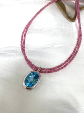 Cargar imagen en el visor de la galería, Pink Tourmaline Blue Topaz Pendant | Double Strand Design by Loulia Pearl Jewelry on elegant fabric.