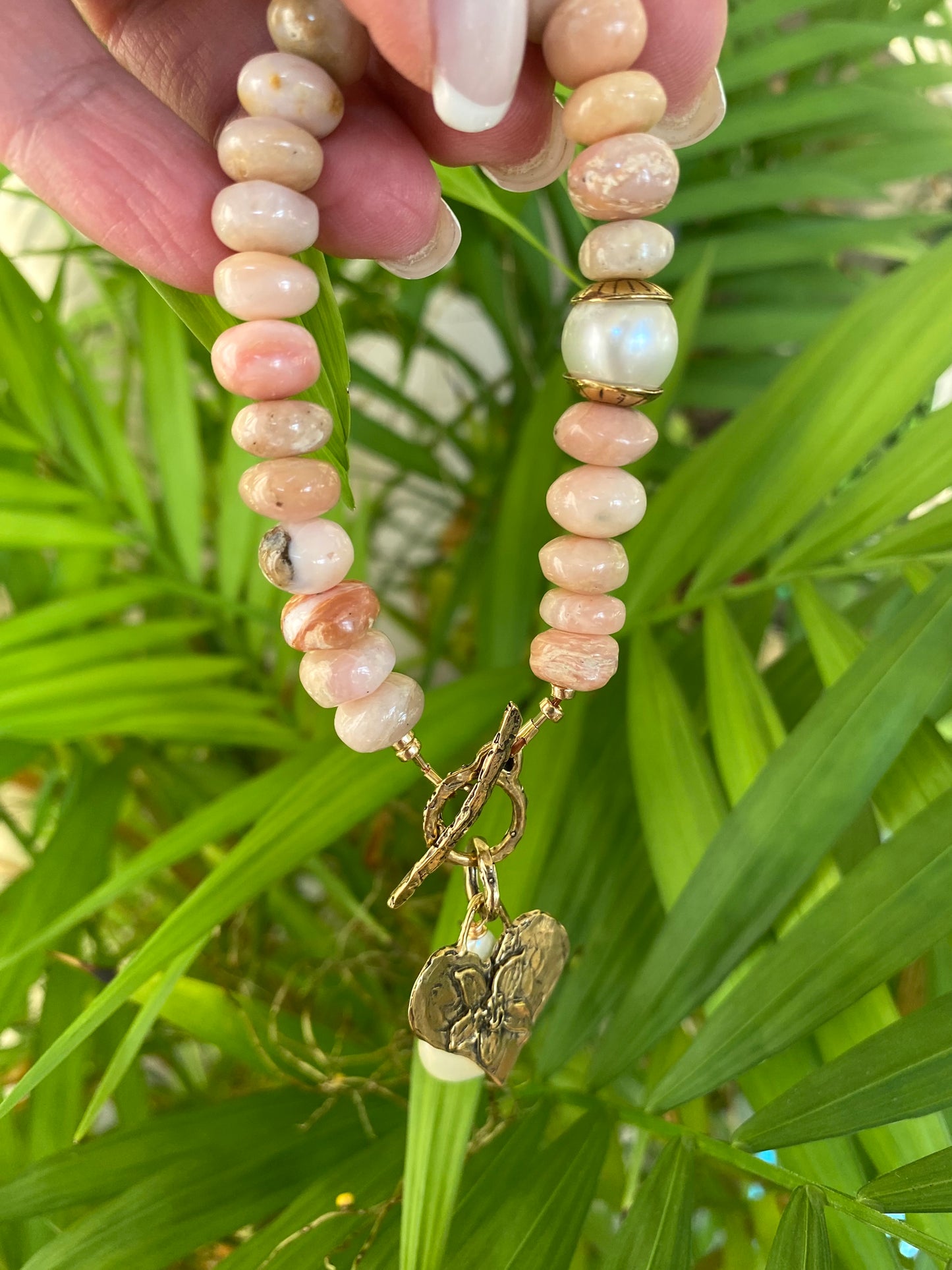 Pink opal bracelet with heart and baroque pearl charm, handcrafted with smooth pink opal beads.