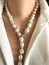 Cargar imagen en el visor de la galería, Edison Pearl necklace worn by a person in a white outfit. pearls are baoque and hand knotted