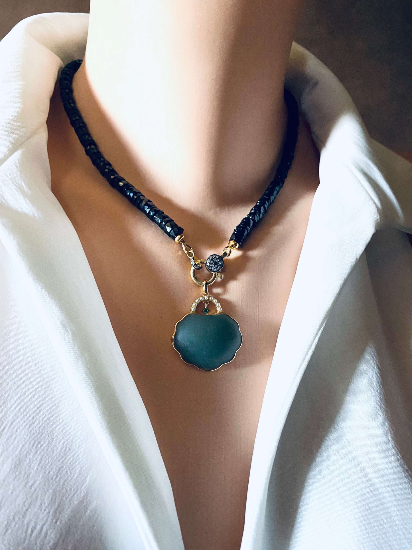 Black spinel beaded necklace with gold vermeil pavé clasp, showcasing elegance and modern luxury.