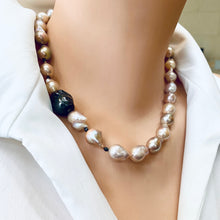 Carica l'immagine nel visualizzatore di Gallery, Side close-up of pink baroque pearl necklace worn by mannequin, black rhodium silver clasp visible.