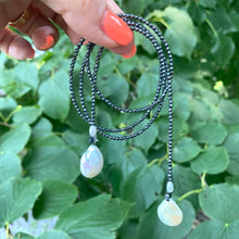 Cargar imagen en el visor de la galería, Hematite and pearl beaded lariat Y necklace featuring a single strand of tiny hematite beads, adorned with a hematite star and a baroque pearl at each end. In 27 to 32 inches, this elegant and versatile necklace adds a unique touch to any outfit.