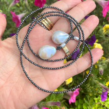 Cargar imagen en el visor de la galería, Hematite and pearl beaded lariat Y necklace featuring a single strand of tiny hematite beads, adorned with a hematite star and a baroque pearl at each end. In 27 to 32 inches, this elegant and versatile necklace adds a unique touch to any outfit.