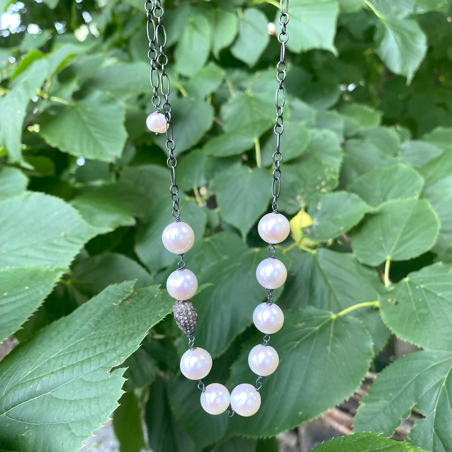 Pearl necklace wire wrapped in silver, featuring high-lustre freshwater pearls, handmade in Canada.
